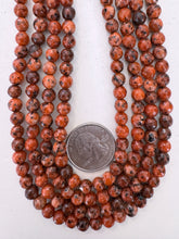 color enhanced serpentine: red orange, 6mm faceted round, 15" strand, sold per strand