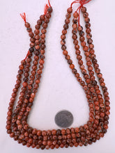 color enhanced serpentine: red orange, 6mm faceted round, 15" strand, sold per strand