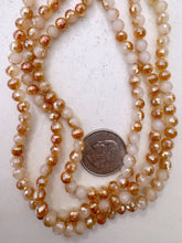 off white, burnt orange ab coated, glass, 6mm fancy cut faceted round, 20" strand, sold per strand