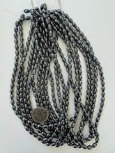 hematite, 8x5mm bowed tube, 15" strand, sold per strand