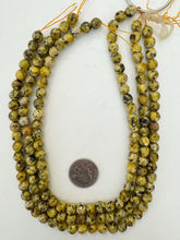 color enhanced serpentine: yellow, 8mm faceted round, 15" strand, sold per strand