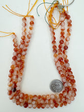 color enhanced quartz: red orange of white, 8mm faceted round, 15" strand, sold per strand