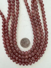 color enhanced quartz: pale ruby red, 8mm round, 15" strand, sold per strand