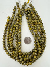 color enhanced serpentine: yellow, 8mm round, 15" strand, sold per strand