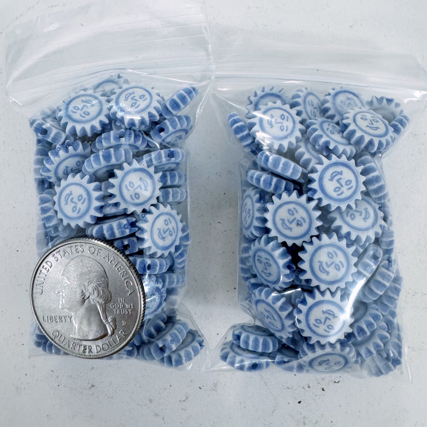 white pale blue, carved design sun face, vintage look acrylic, 11x11x3mm sun face coin,  sold per approximately 28 gram bag