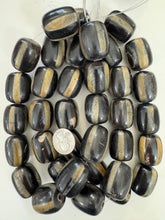 black off white golden horn, stripe motif, 32x24mm barrel tube, 15" strand, sold per strand