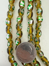 amber yellow metallic silver green orange, dotted motif, vintage stock glass, 9x7mm bowed tube barrel mix, 15" strand, SOLD PER STRAND