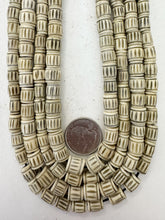 off white grey, carved lines motif, vintage stock bone, 8-10mm barrel size mix, 15" strand, SOLD PER STRAND