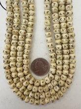 off white brown black, carved x motif, vintage stock bone, 8x6mm rondelle, 15" strand, SOLD PER STRAND