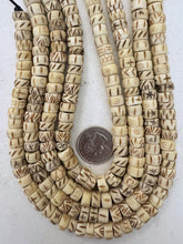 off white, carved dark designs mixed motif, vintage stock bone, 10x6mm rondelle, 15" strand, SOLD PER STRAND