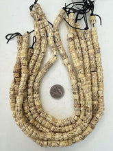 off white, carved dark designs mixed motif, vintage stock bone, 10x6mm rondelle, 15" strand, SOLD PER STRAND