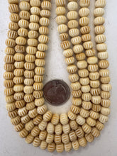 off white, carved lines motif, vintage stock bone, 9x7mm rondelle, 15" strand, sold per strand