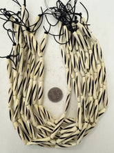 off white, carved spiral dark lines motif, vintage stock bone, 36x6mm tube, 15" strand, sold per strand