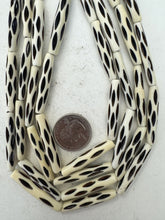 off white, carved repeated dark lines motif, vintage stock bone, 37x6mm tube, 15" strand, sold per strand
