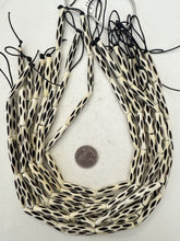 off white, carved repeated dark lines motif, vintage stock bone, 37x6mm tube, 15" strand, sold per strand