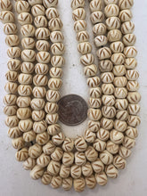 off white, carved dark criss crossing lines motif, vintage stock bone, 10x8mm rondelle, 15" strand, sold per strand