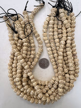 off white, carved dark criss crossing lines motif, vintage stock bone, 10x8mm rondelle, 15" strand, sold per strand