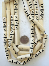 off white, carved dark lines x motif, vintage stock bone, 37x10x8mm flattened tube, 15" strand, sold per strand