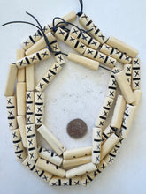 off white, carved dark lines x motif, vintage stock bone, 37x10x8mm flattened tube, 15" strand, sold per strand