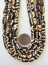 dark brown off white, mixed design motifs, vintage stock bone, 13x7mm tube, 15" strand, sold per strand