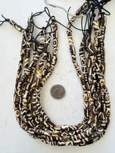 dark brown off white, mixed design motifs, vintage stock bone, 13x7mm tube, 15" strand, sold per strand